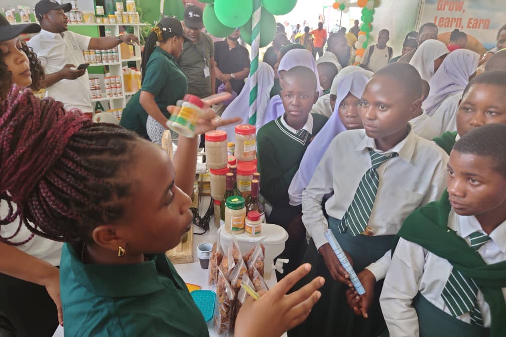 Patra presenting banana crisps to visitors at a trade fair